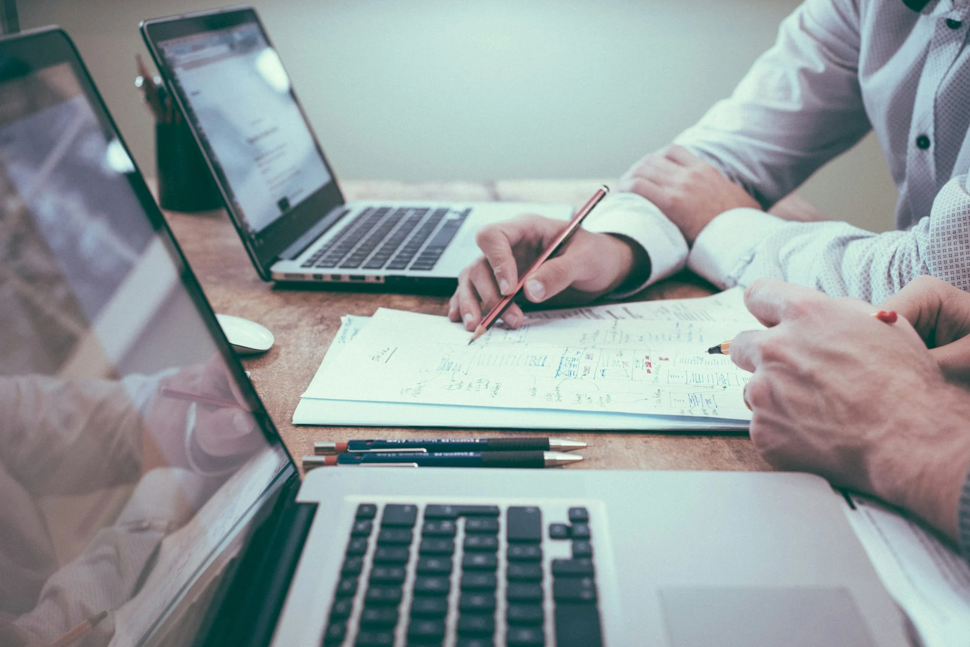 Two linguists analyzing and annotating technical and legal documents
